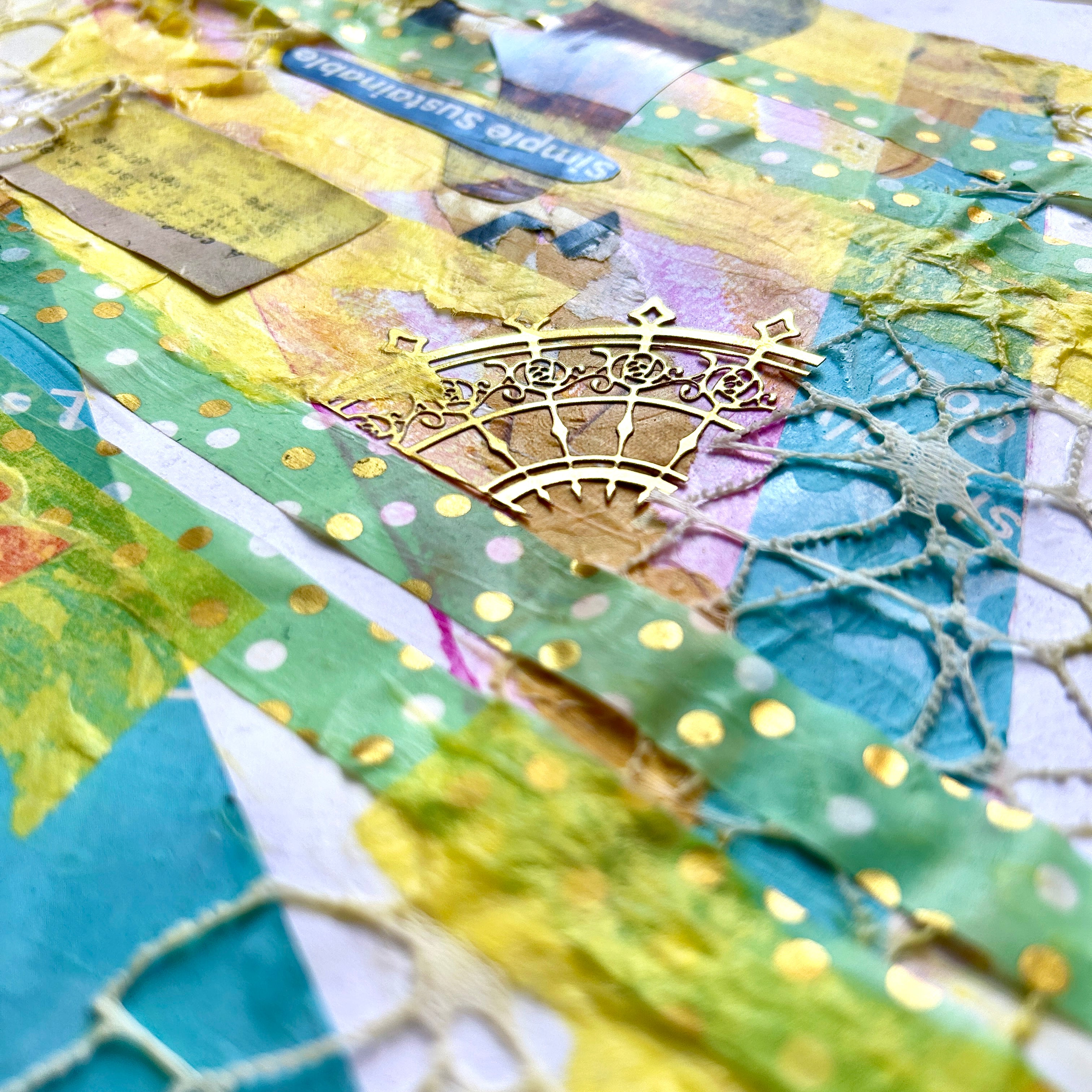 Close-up of a textured fabric with patterns and a metallic embellishment. A yellow and teal mixed media collage reflecting on the joy found in life when you thoughts, actions, and emotions align with your values. 