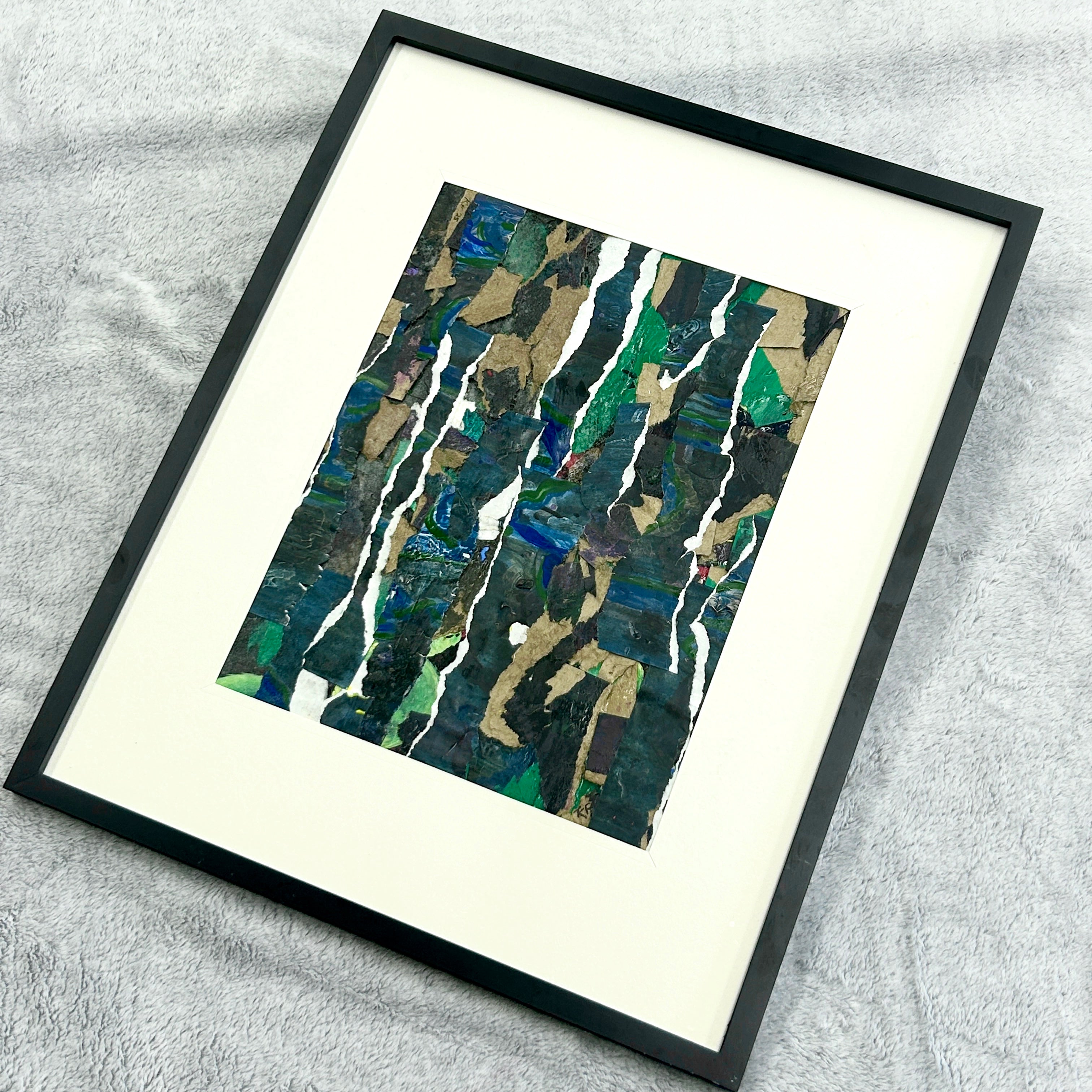 Framed abstract art piece on a textured surface. Representing growth and stability forged in tough times.