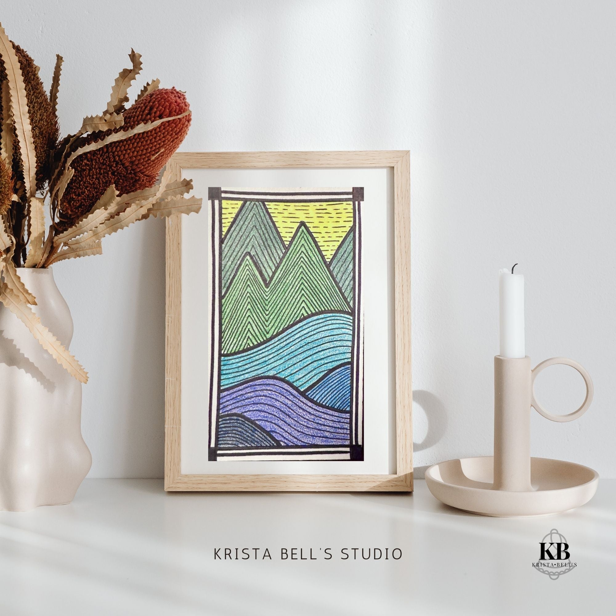 Framed abstract art print with geometric design on a white surface, featuring 'Krista Bell's Studio' branding.
