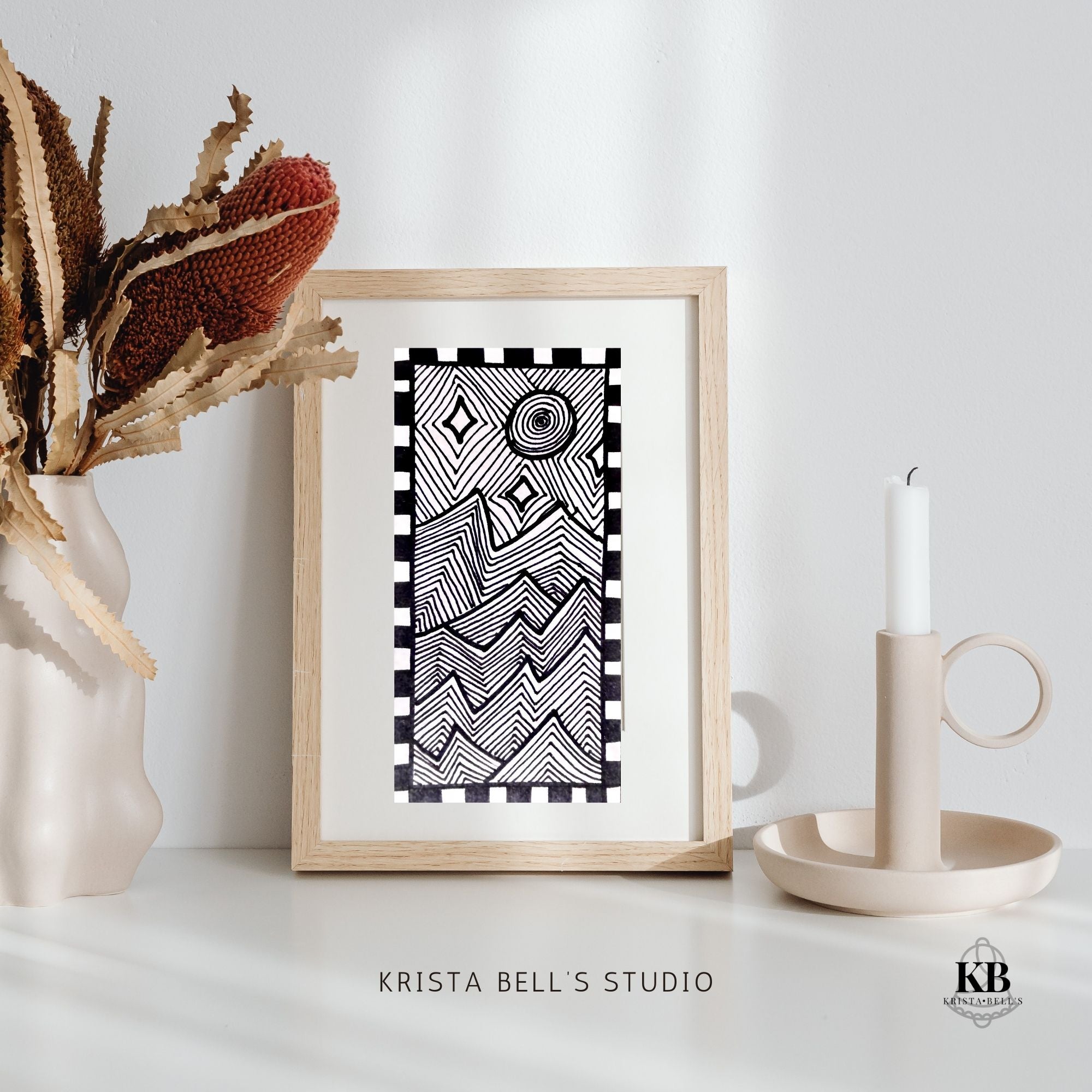 Framed black and white modern abstract line art patterned of jagged mountains in the moon light. Artwork framed and displayed in a calming setting.
