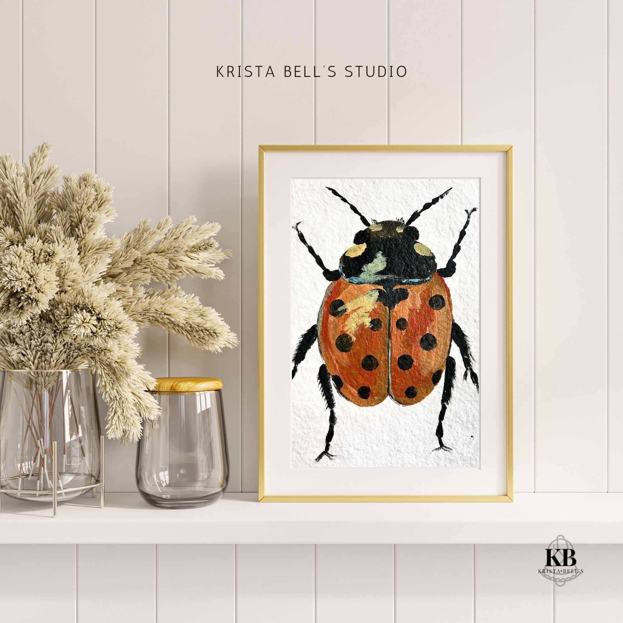 Framed artwork of a beetle on a white wall with decorative jars and plants.