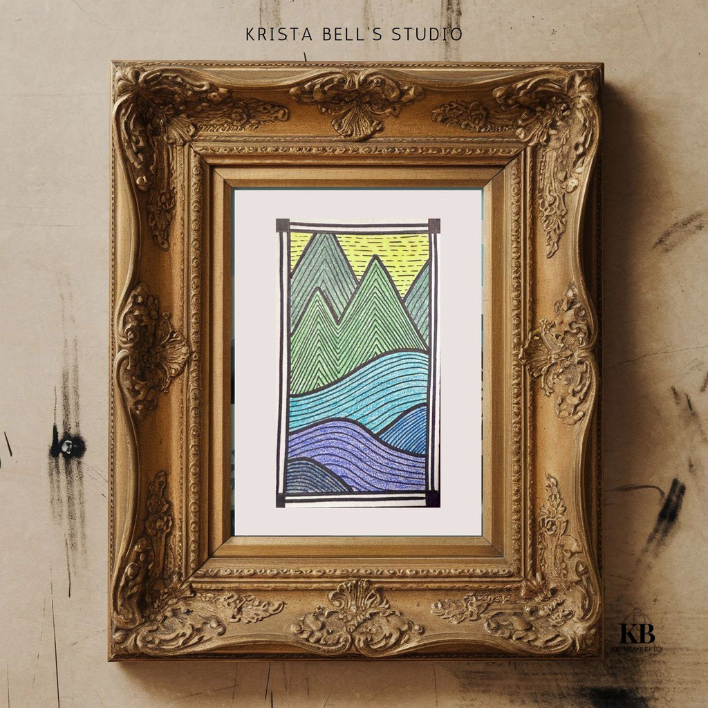 Framed artwork of mountains with 'Krista Bell's Studio' branding on a textured wall.
