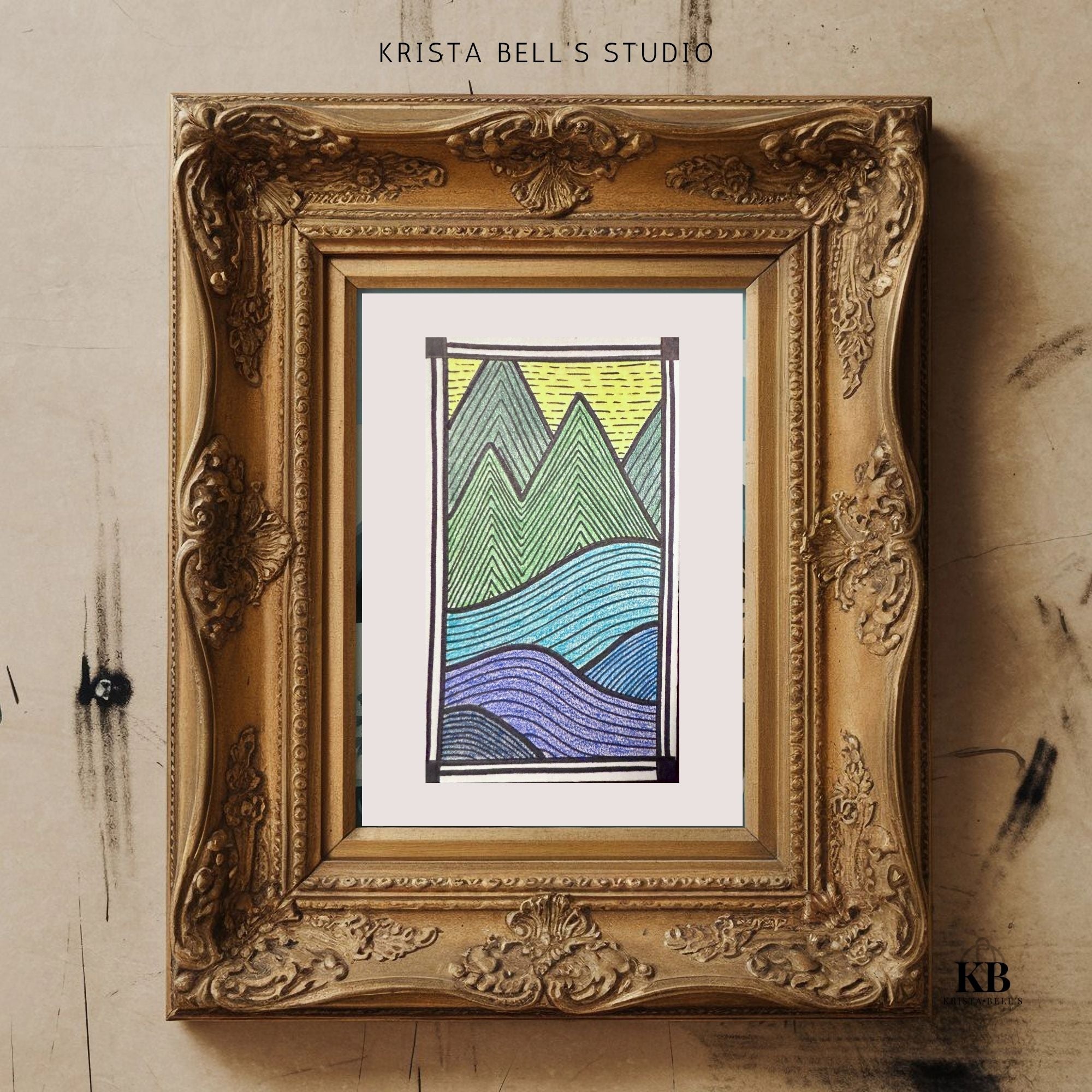 Framed artwork of mountains with 'Krista Bell's Studio' branding on a textured wall.