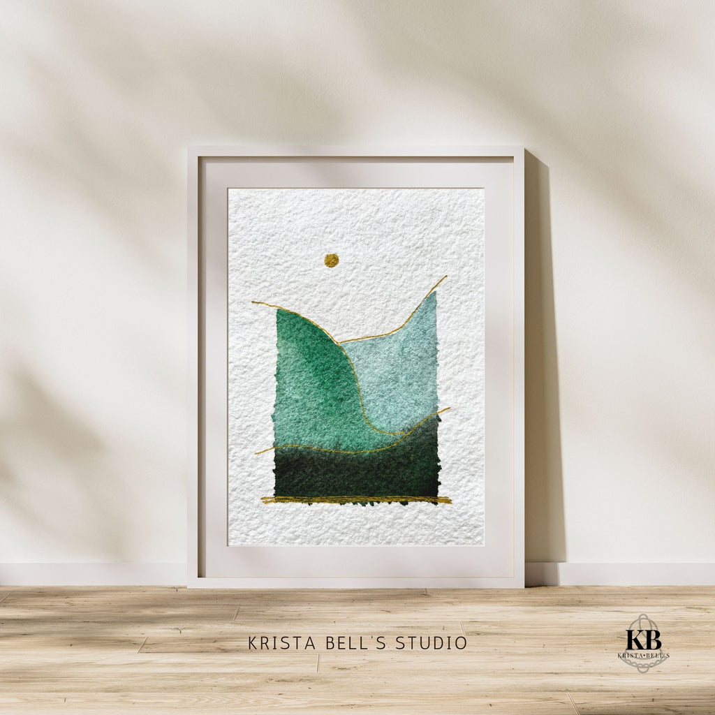 Framed abstract art piece on a wall with 'Krista Bell's Studio' branding.
