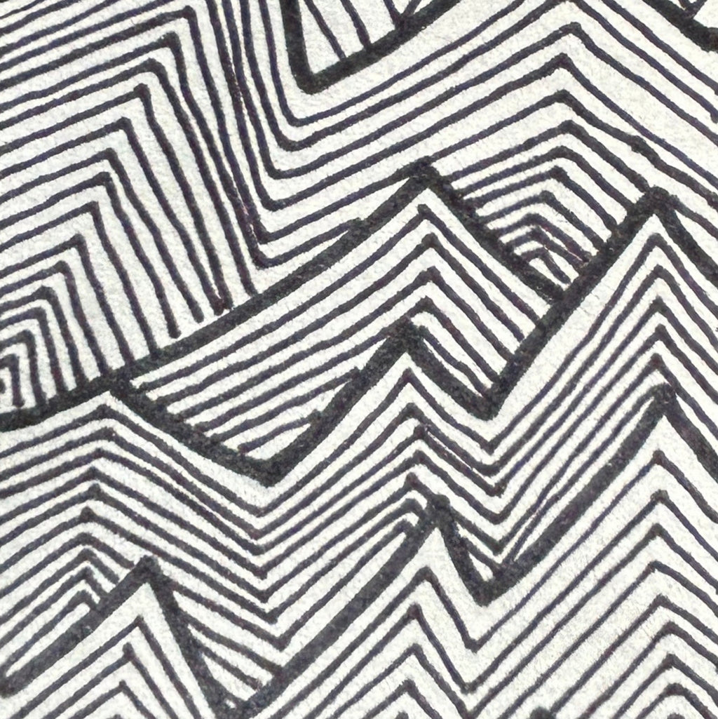 Close up of a black ink drawing, geometric zig zag pattern on a white background.