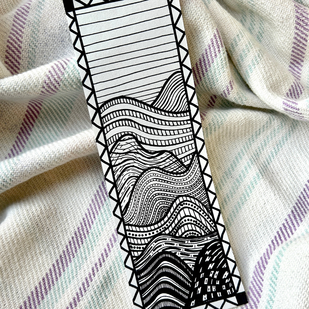 Black and white patterned strip on a textured fabric background