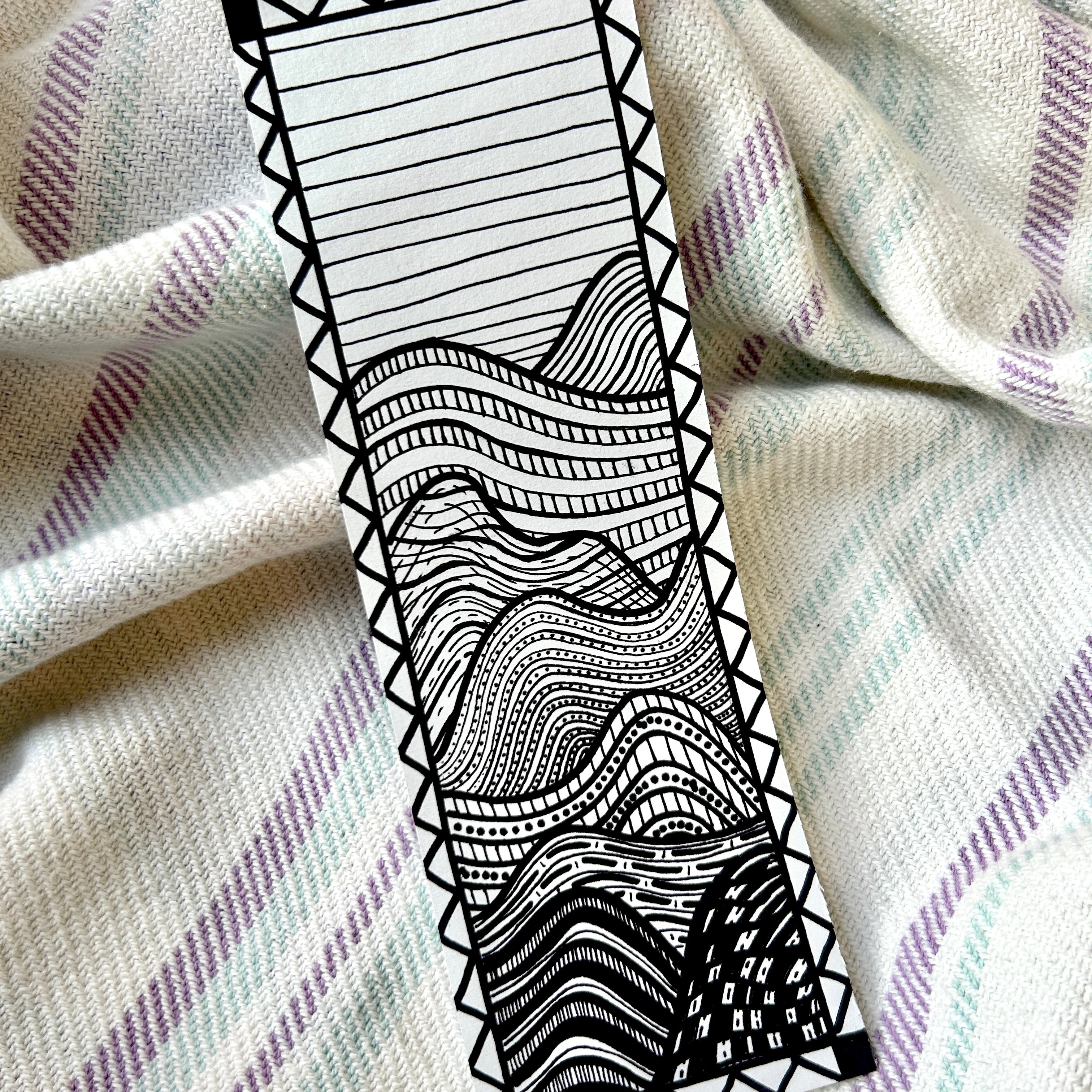 Black and white patterned strip on a textured fabric background