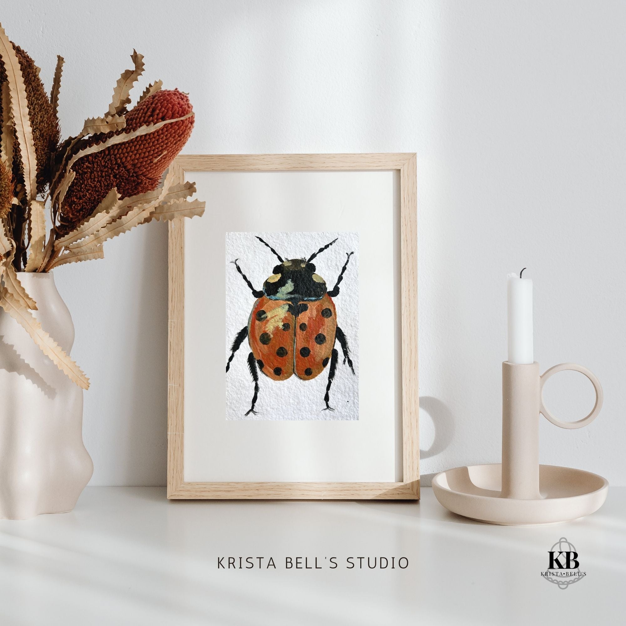 A framed original painting of a strong steady ladybug.