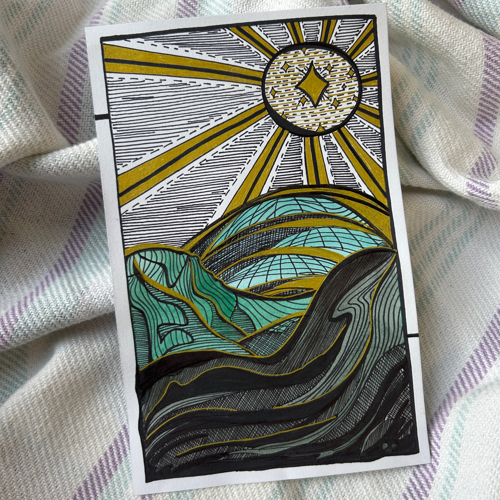 Decorative card with sun and wave design on a textured fabric background