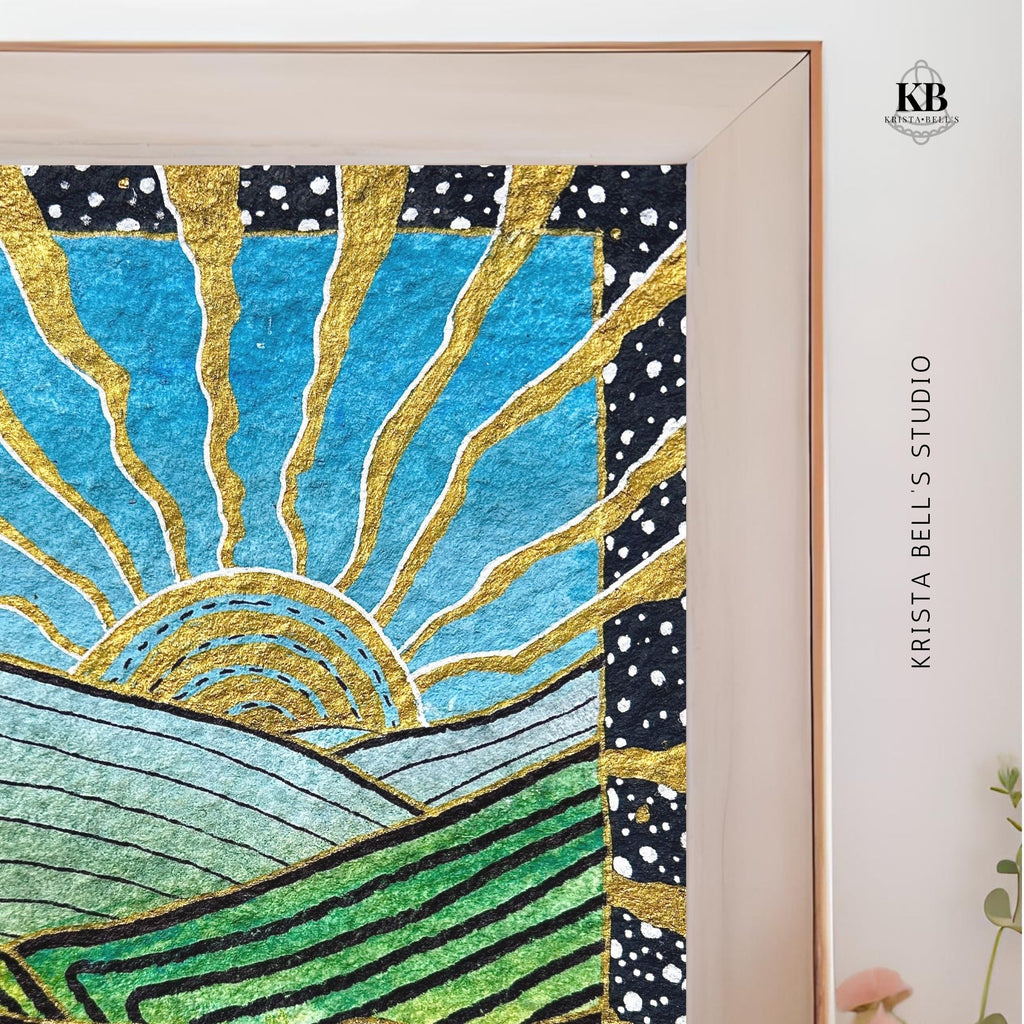 Framed artwork with abstract design of a sun and landscape, featuring gold, blue, and green colors.
