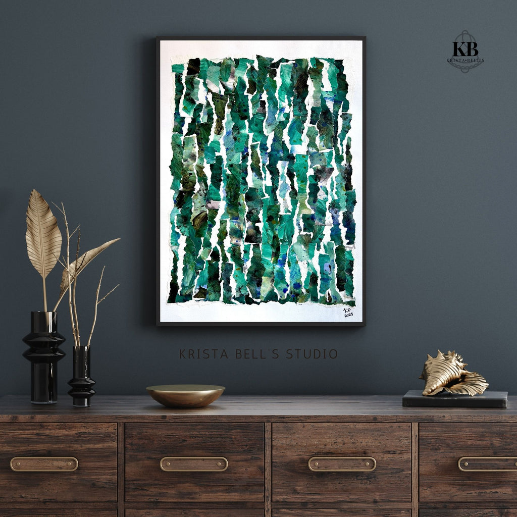 Abstract art print on a moody slate blue wall above a wooden console table with decorative items.