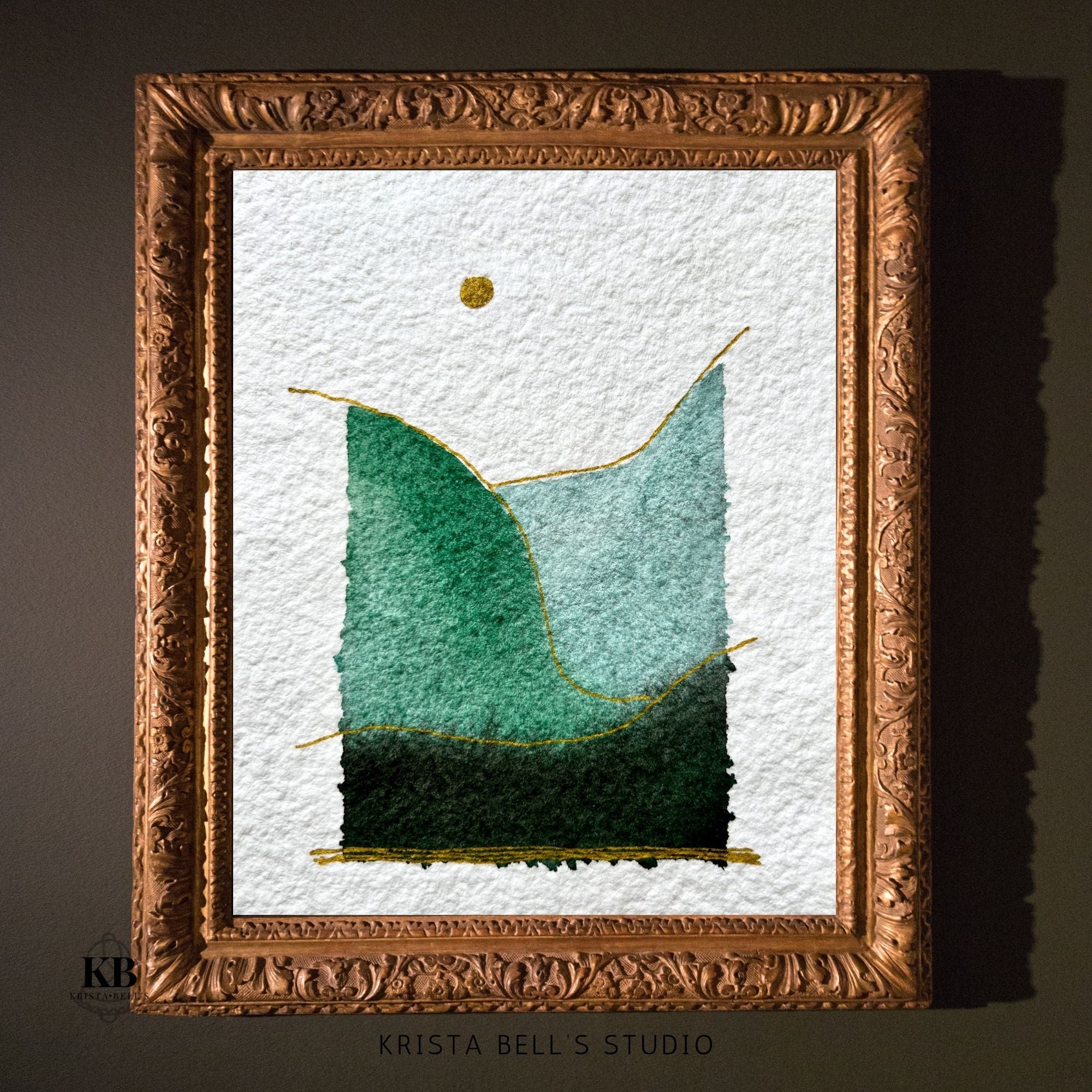 Framed artwork of simple modern watercolor landscape on a textured white background, branded 'Krista Bell's Studio'.