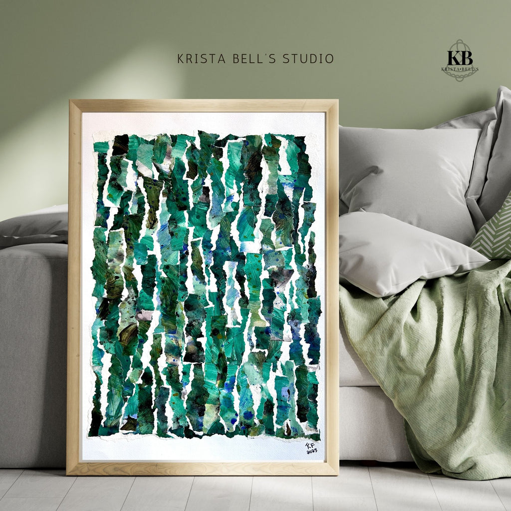 Framed abstract art print with green patterns leaning against a bed.