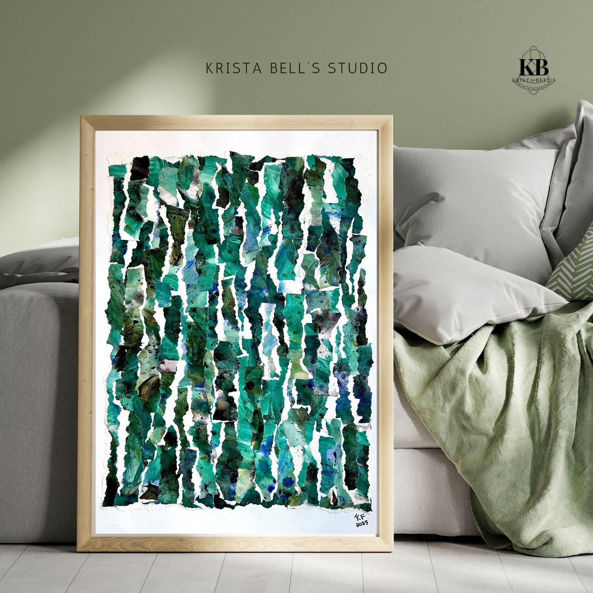 Framed abstract art print with green patterns leaning against a bed.