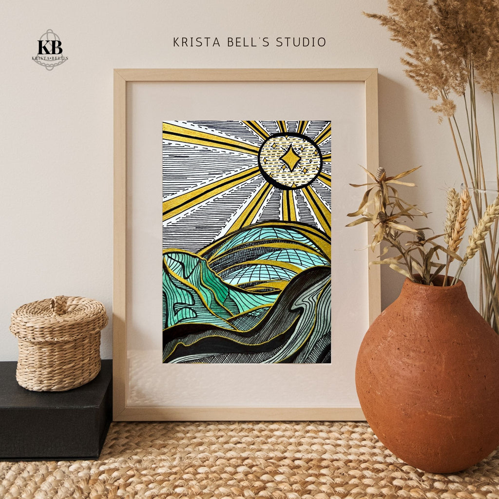 Framed artwork with abstract design of sun and mountains, placed on a textured surface with decorative elements.
