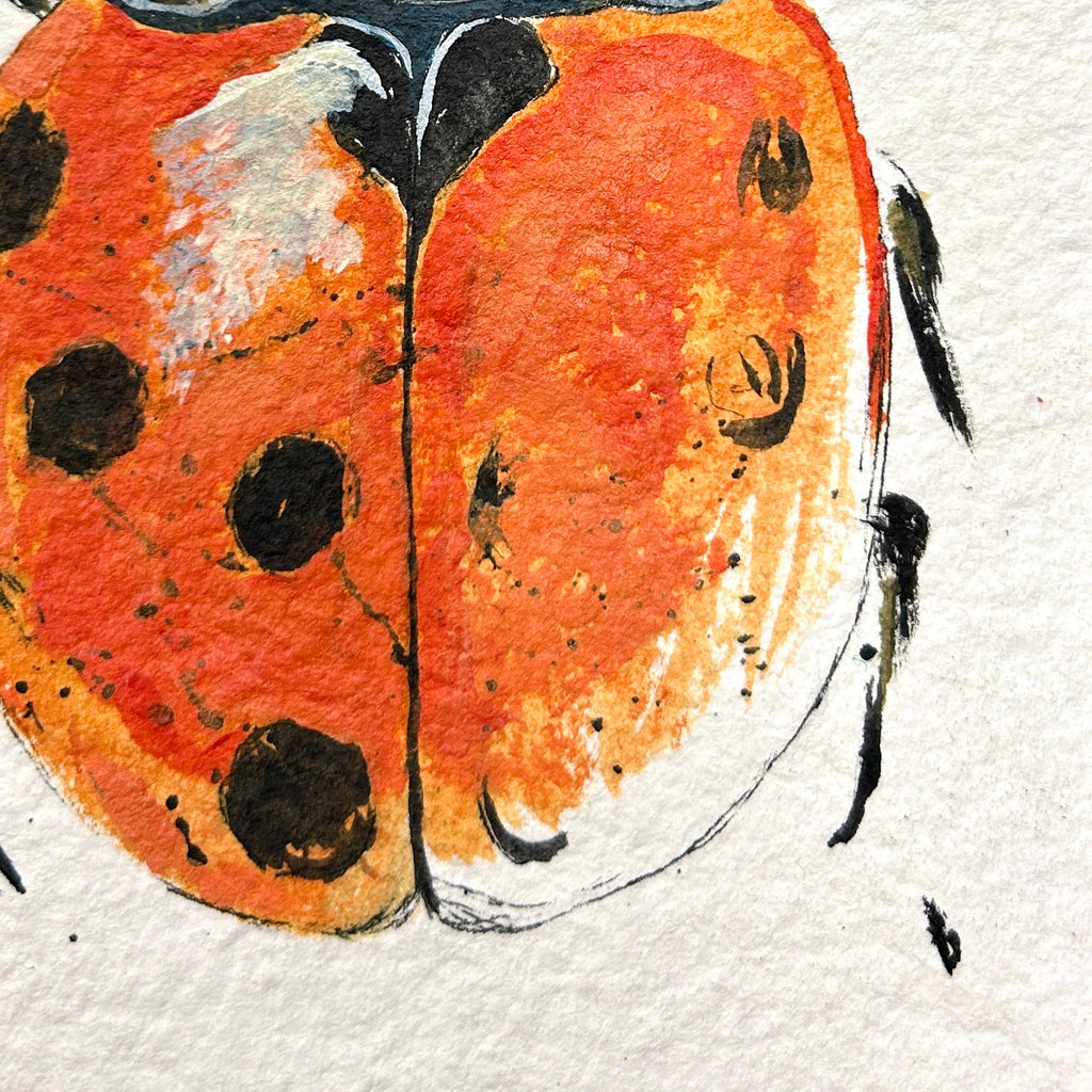 Artistic depiction of a ladybug on textured paper