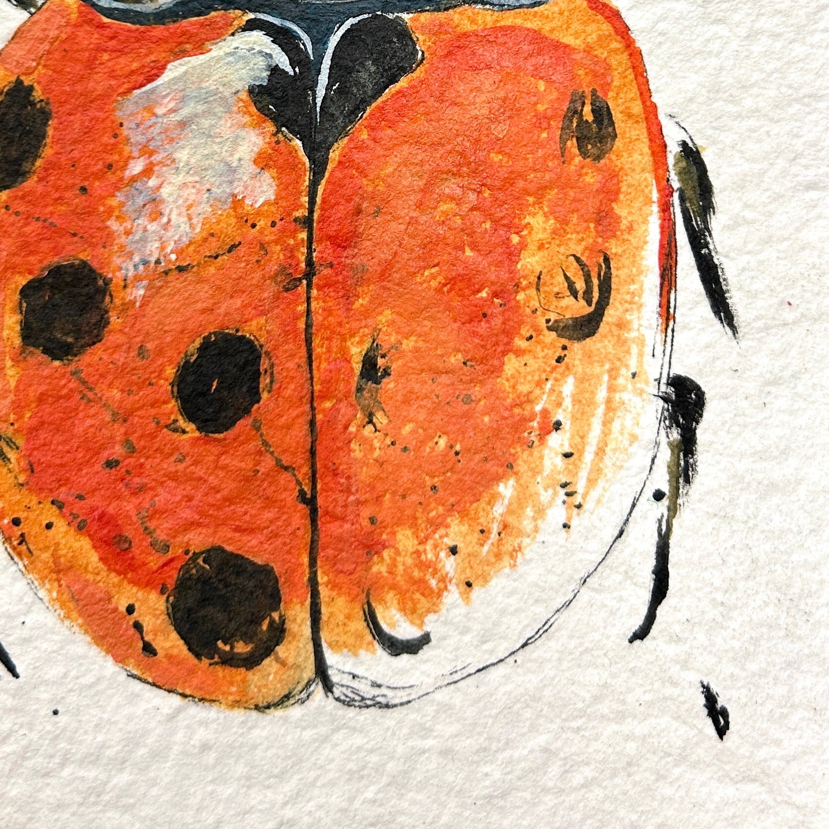 Artistic depiction of a ladybug on textured paper