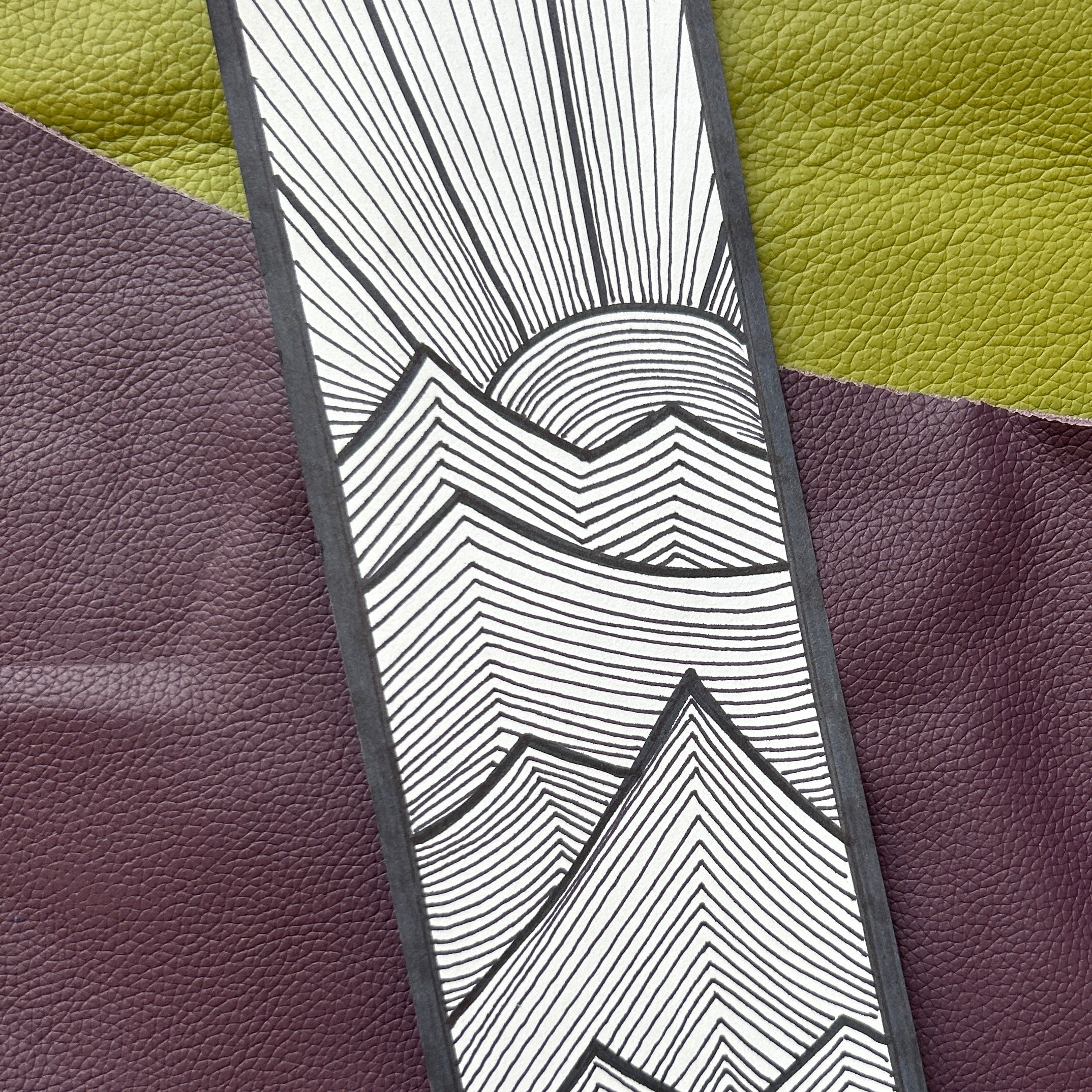 Black and white abstract design on a textured purple and green background