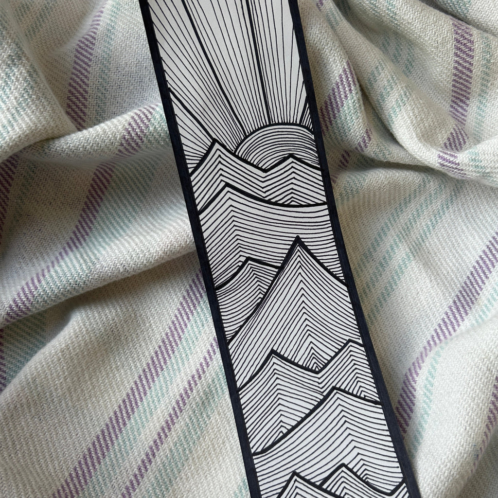 Black and white geometric pattern on a textured fabric background
