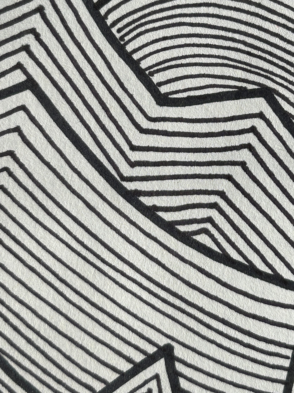 Close-up of a black and white geometric pattern artwork.