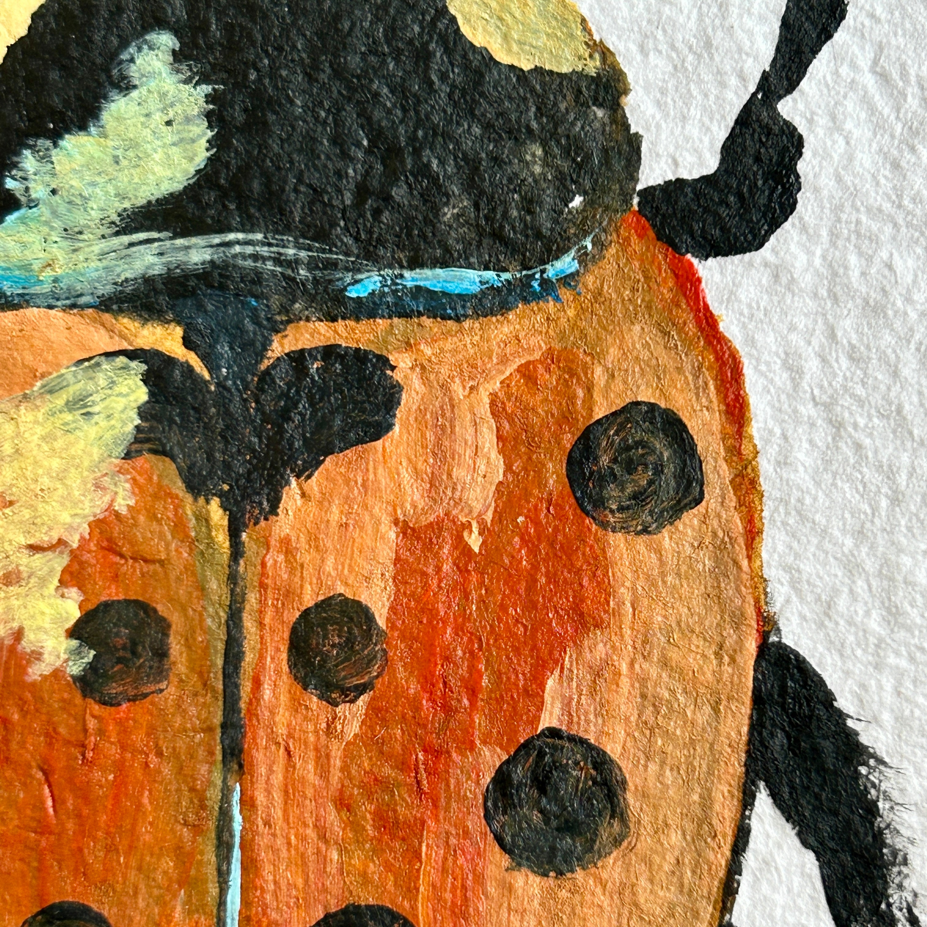 Painted ladybug on a textured white background