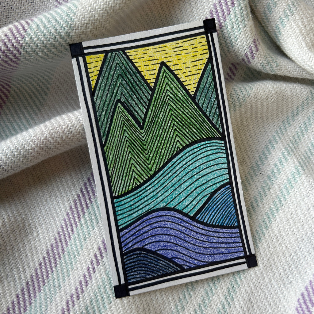 Colorful mountain design on a textured fabric background
