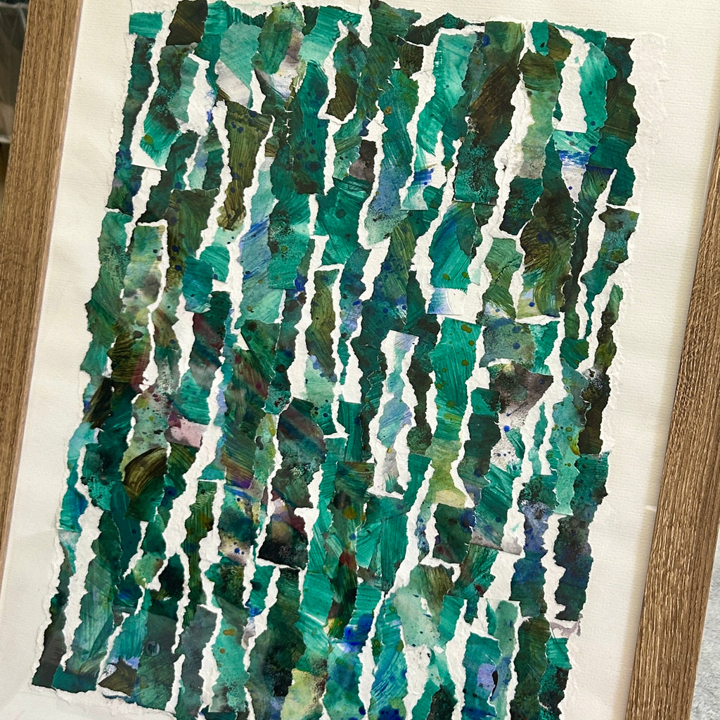 Framed Abstract art piece with green and blue patterns on a white background