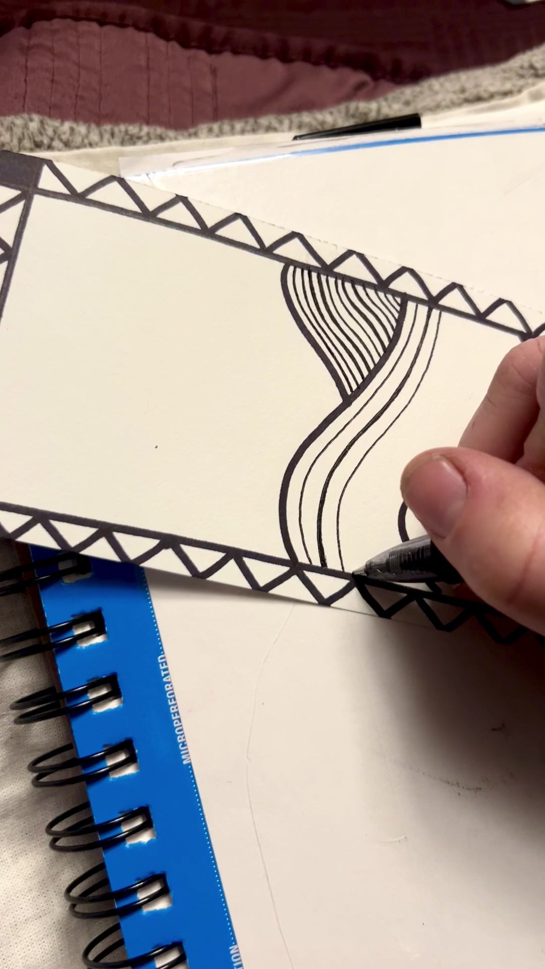 Short video showing the artist working on the original ink line landscape drawing.
