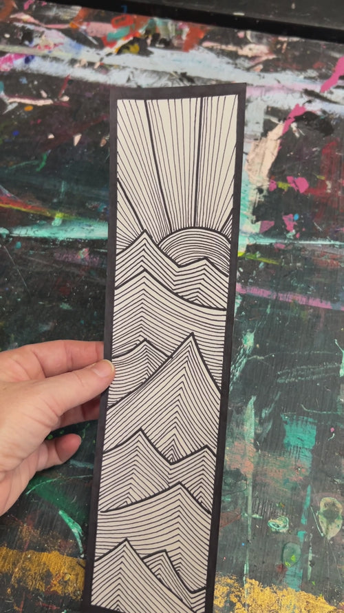 short video showing the original modern ink drawing of sharp waving lines with a sun rising above the turbulence.