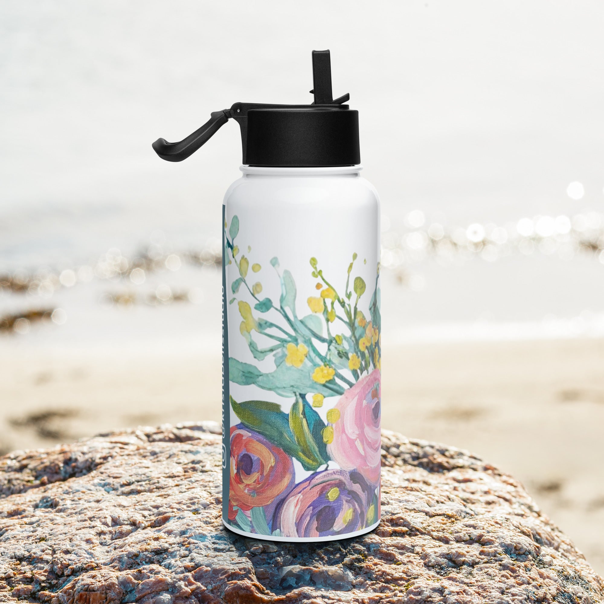 Product mockup of a 32oz stainless steel water bottle, with painted flowers on it.